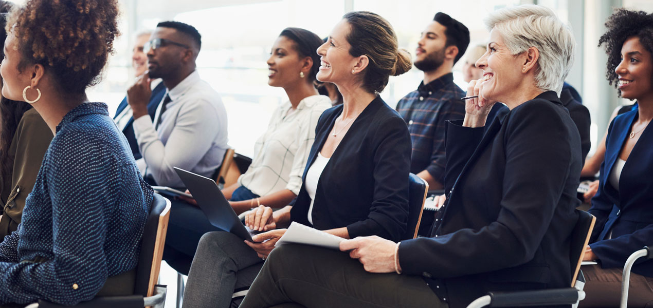 An audience of business people attending a conference.